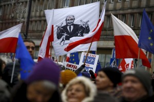People gather during an anti-government demonstration for free media in front of the Television headquarter in Warsaw, January 9, 2016. A banner (C) shows Law and Justice leader Jaroslaw Kaczynski. REUTERS/Kacper Pempel - RTX21N5N