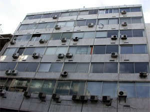 photo of haphazard installation of split aircon units in a tower block